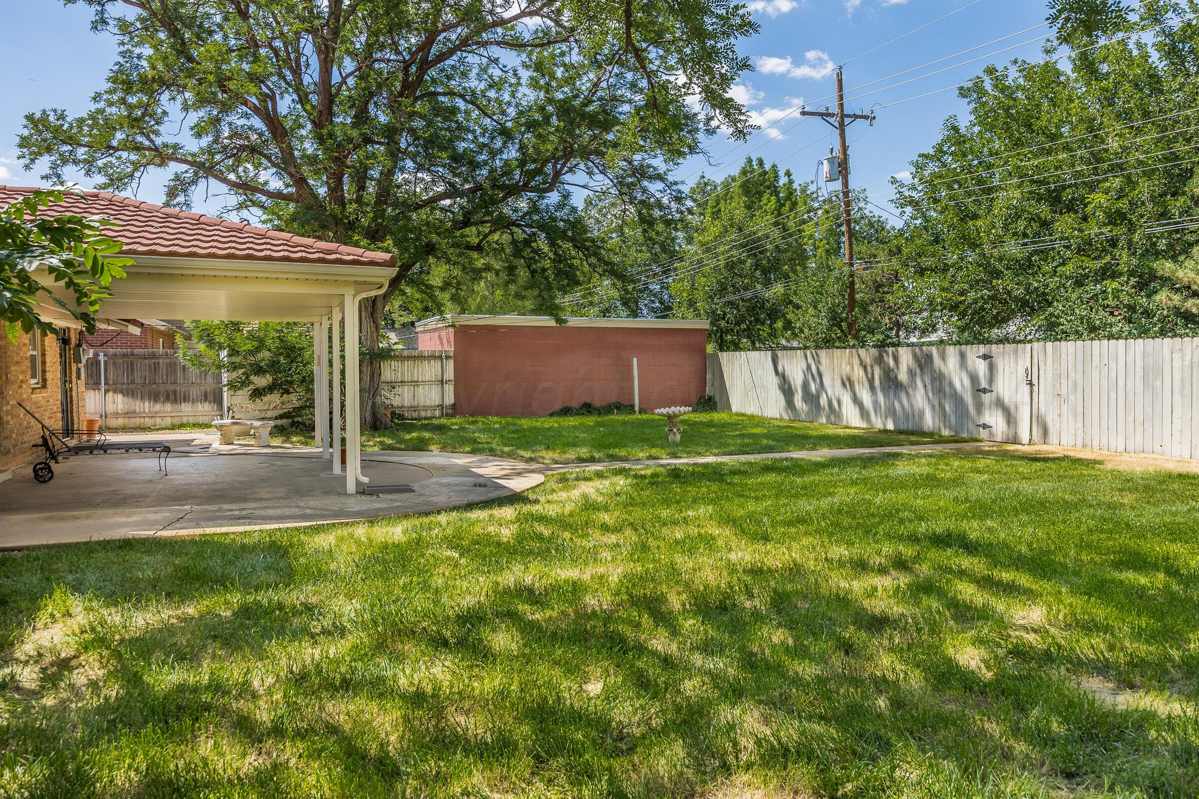 5502 Brinkman Drive Amarillo, TX 79106 - Photo 22 of 22 a view of a backyard with a small cabin