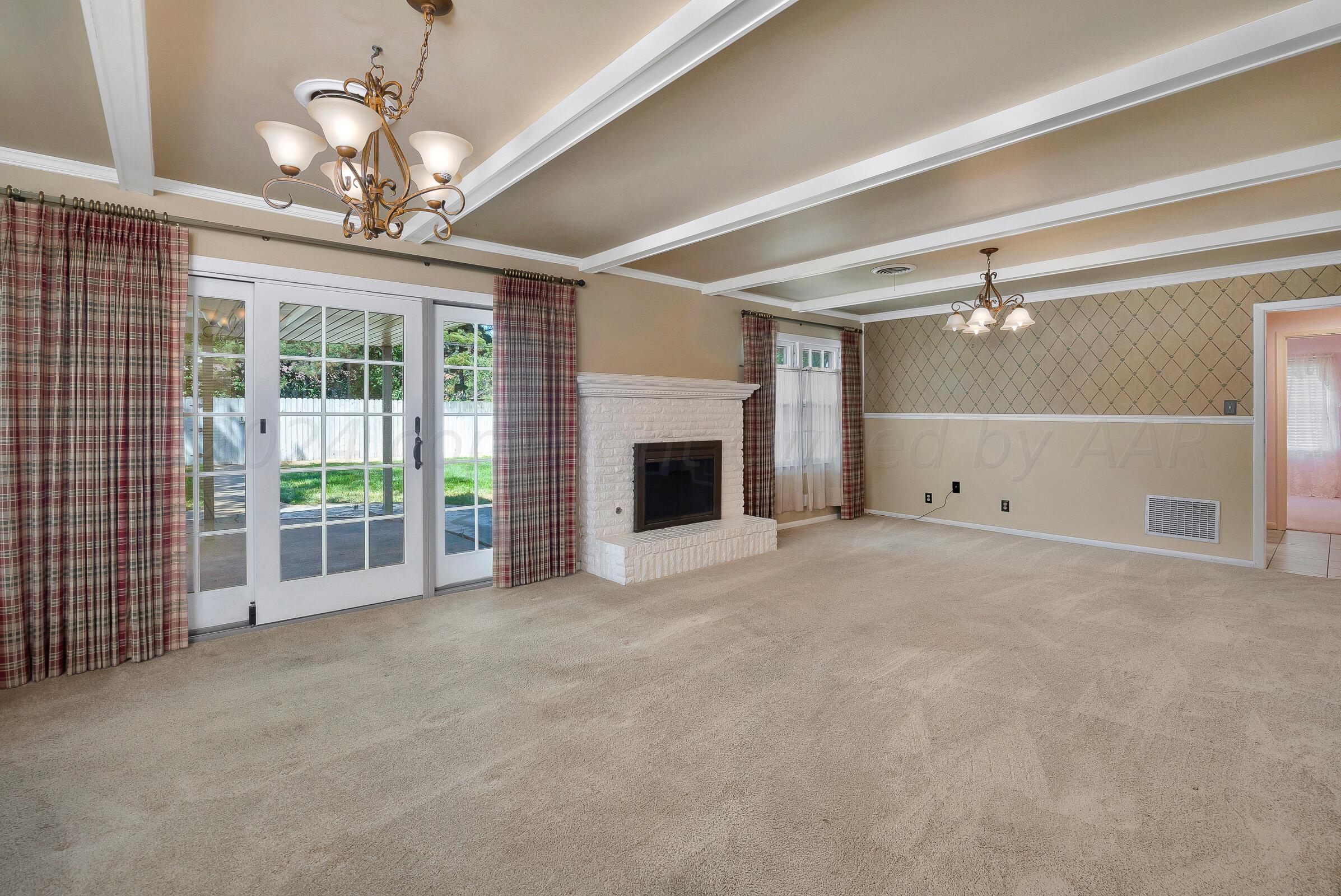 5502 Brinkman Drive Amarillo, TX 79106 - Photo 8 of 22 a view of a livingroom with a chandelier fan and windows