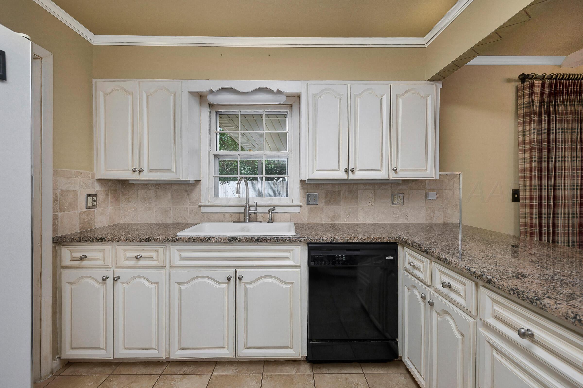 5502 Brinkman Drive Amarillo, TX 79106 - Photo 10 of 22 a kitchen with granite countertop a sink and cabinets