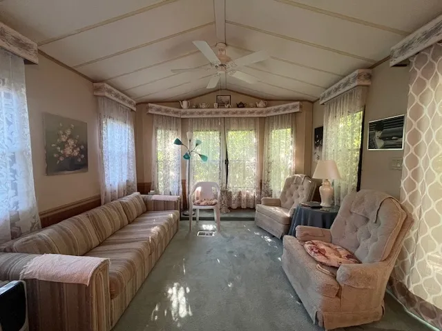 a spacious bedroom with a bed and a large mirror on the dresser