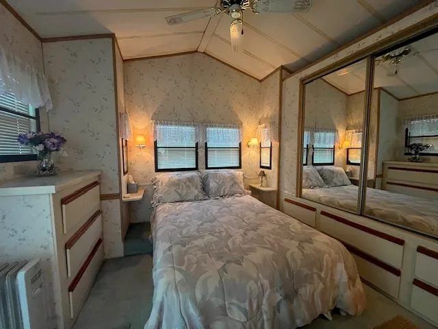 a bed sitting in a bedroom next to a window