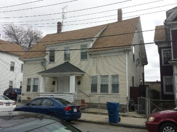 29-31 Washington Street Lawrence, MA 01841 - Photo 2 of 5 a front view of a house with cars parked