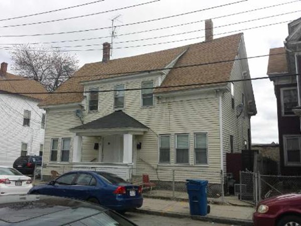 29-31 Washington Street Lawrence, MA 01841 - Photo 3 of 5 a front view of a house with cars parked
