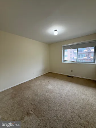 an empty room with a empty space and windows