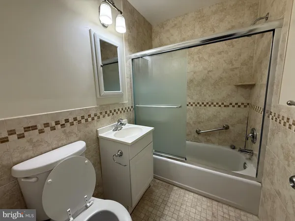 a bathroom with a toilet sink and shower