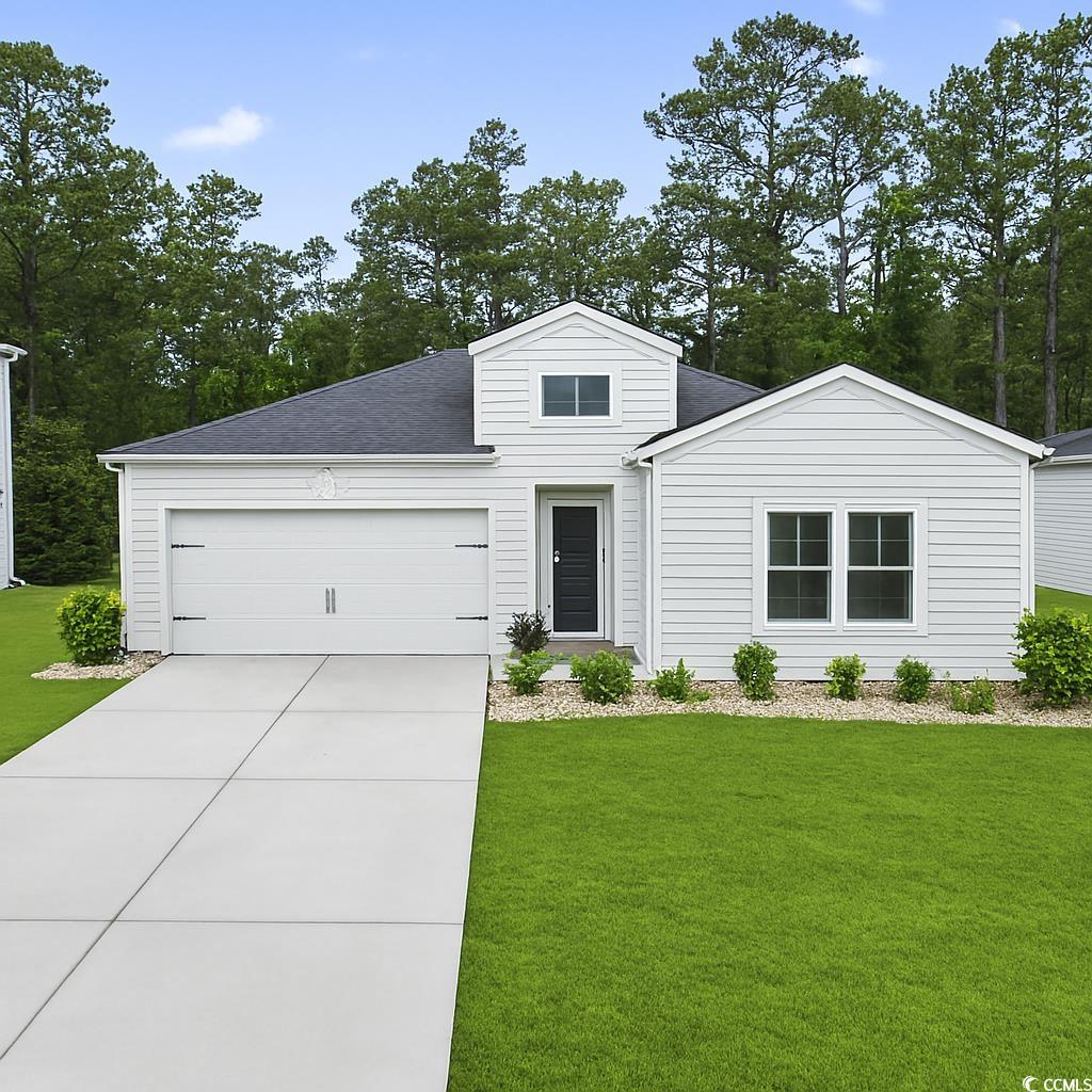 315 North Reindeer Road Surfside Beach, SC 29575 - Photo 1 of 35 View of front of home featuring a garage, driveway, a front lawn, and a shingled roof