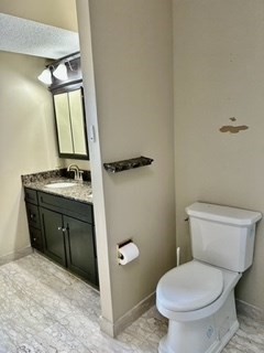 40 Village Road, Unit 1704 (PH4) Middleton, MA 01949 - Photo 21 of 35 a bathroom with a toilet sink and mirror