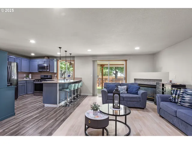 a living room with furniture kitchen and a table