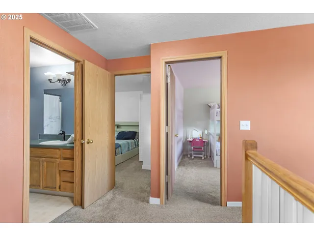 a bedroom with a bed and a large mirror