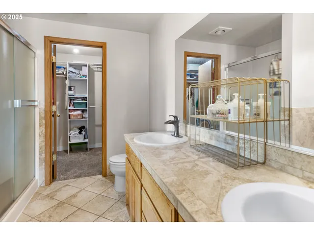 a en suite bathroom with a sink a mirror and a shower