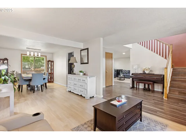 a living room with furniture and a dining table