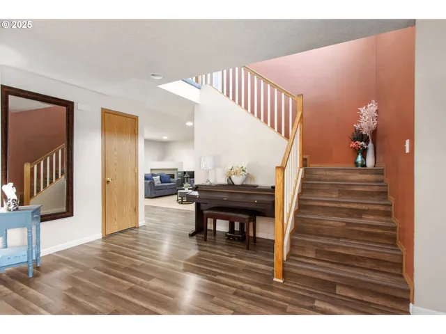 a view of entryway and hall with wooden floor