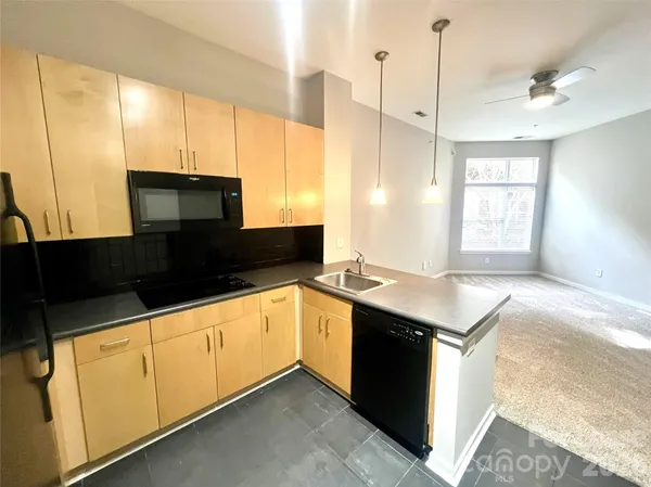 a kitchen with stainless steel appliances a sink a stove and a refrigerator