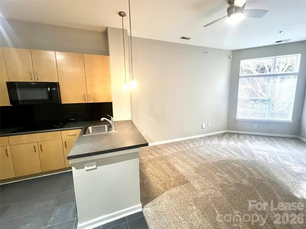 a kitchen with stainless steel appliances granite countertop a sink and a stove