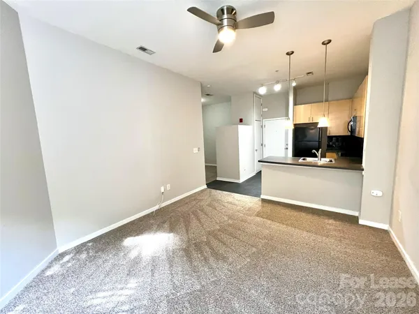 a view of a kitchen with a sink and a refrigerator
