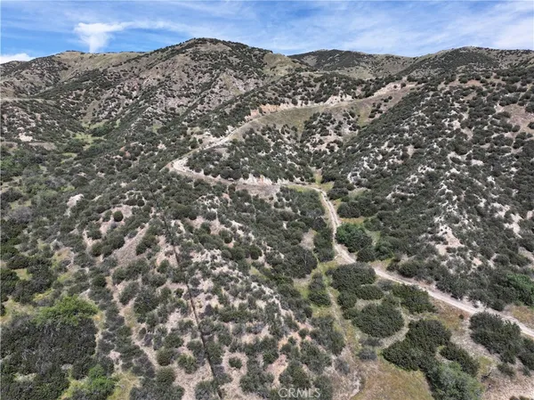 view of a mountain range in a cloudy sky