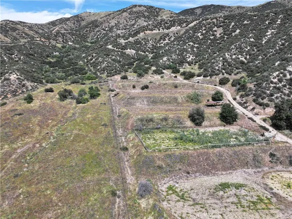a view of a dry yard with mountains
