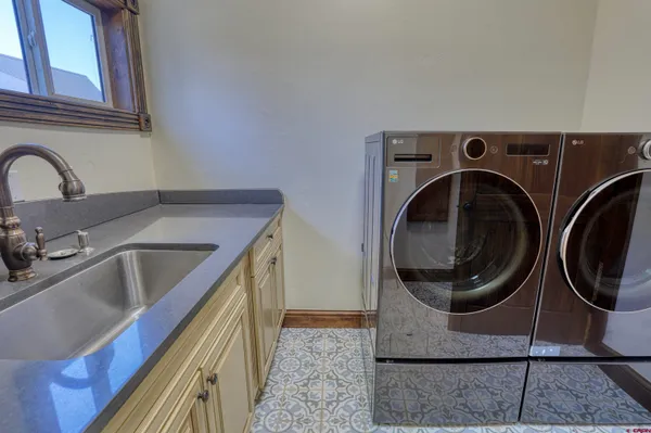 a utility room with sink dryer and washer