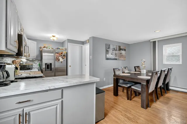 a view of a kitchen area with furniture and wooden floor