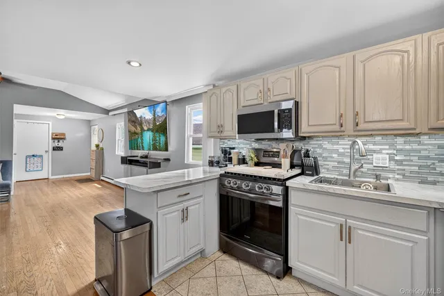 a kitchen with a sink stove and cabinets