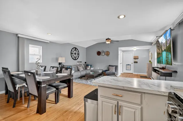 a view of a kitchen area with furniture and wooden floor