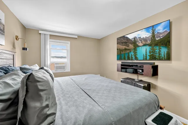 a bed sitting in a bedroom next to a window