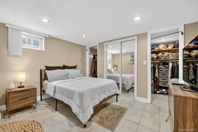 a bedroom with a bed and a view of walk in closet