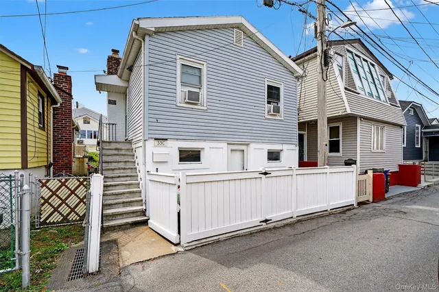 a view of a house with more wooden fence