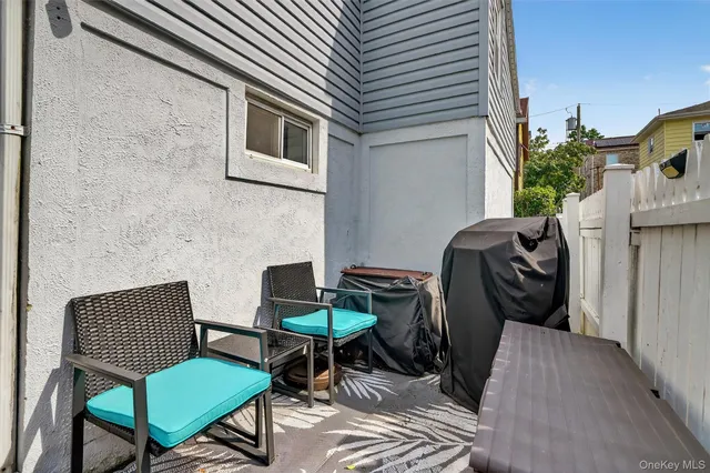 a view of a patio with couple of chairs