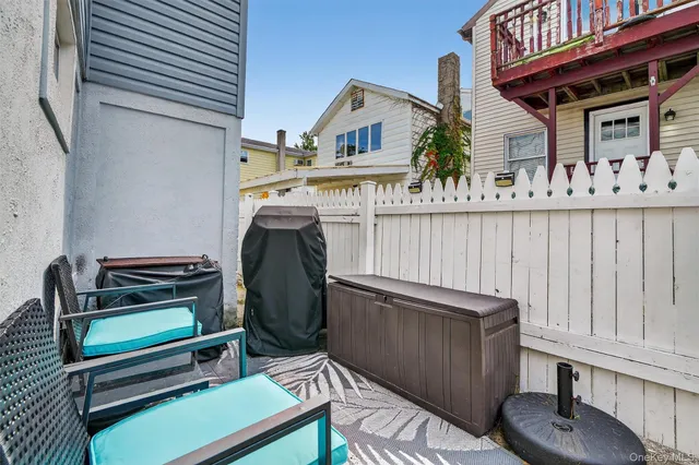 a view of a chair and tables in the balcony