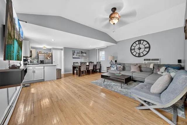 a living room with furniture and kitchen view