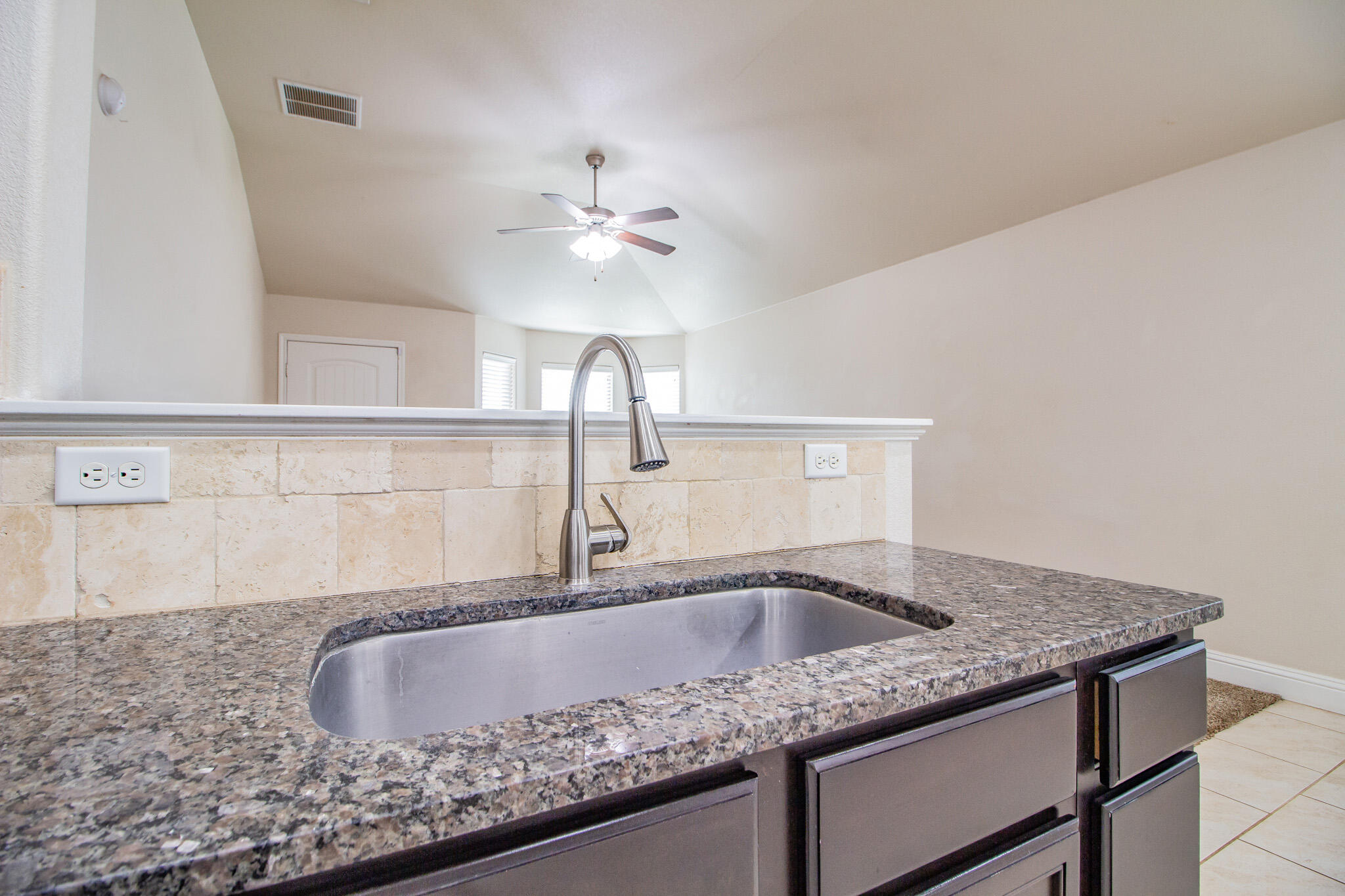 7409 101st Street Lubbock, TX 79424 - Photo 10 of 22 a kitchen with granite countertop a sink and dishwasher