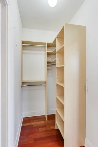 a view of a livingroom with wooden floor and a ceiling fan
