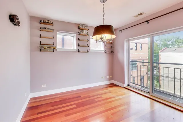 a view of a room with wooden floor and a window