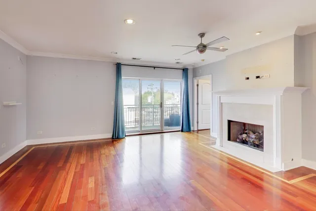 a view of a kitchen with wooden floor and a ceiling fan