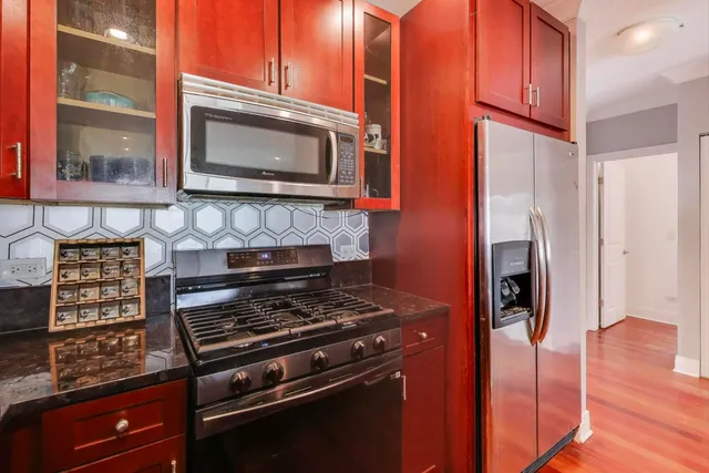 a view of a big room with wooden floor and windows