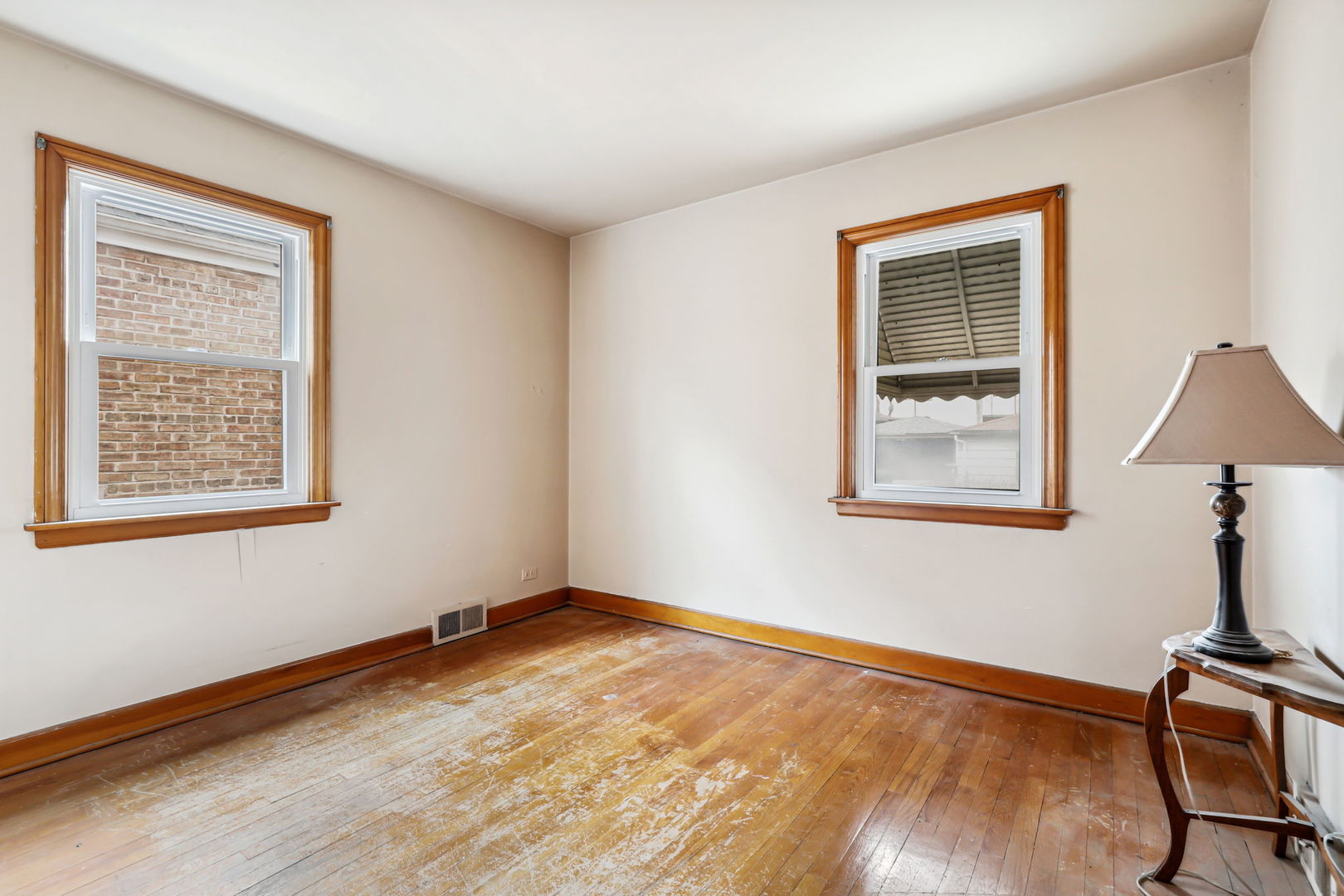 1822 23rd Avenue Melrose Park, IL 60160 - Photo 8 of 20 a view of an empty room with a window and wooden floor