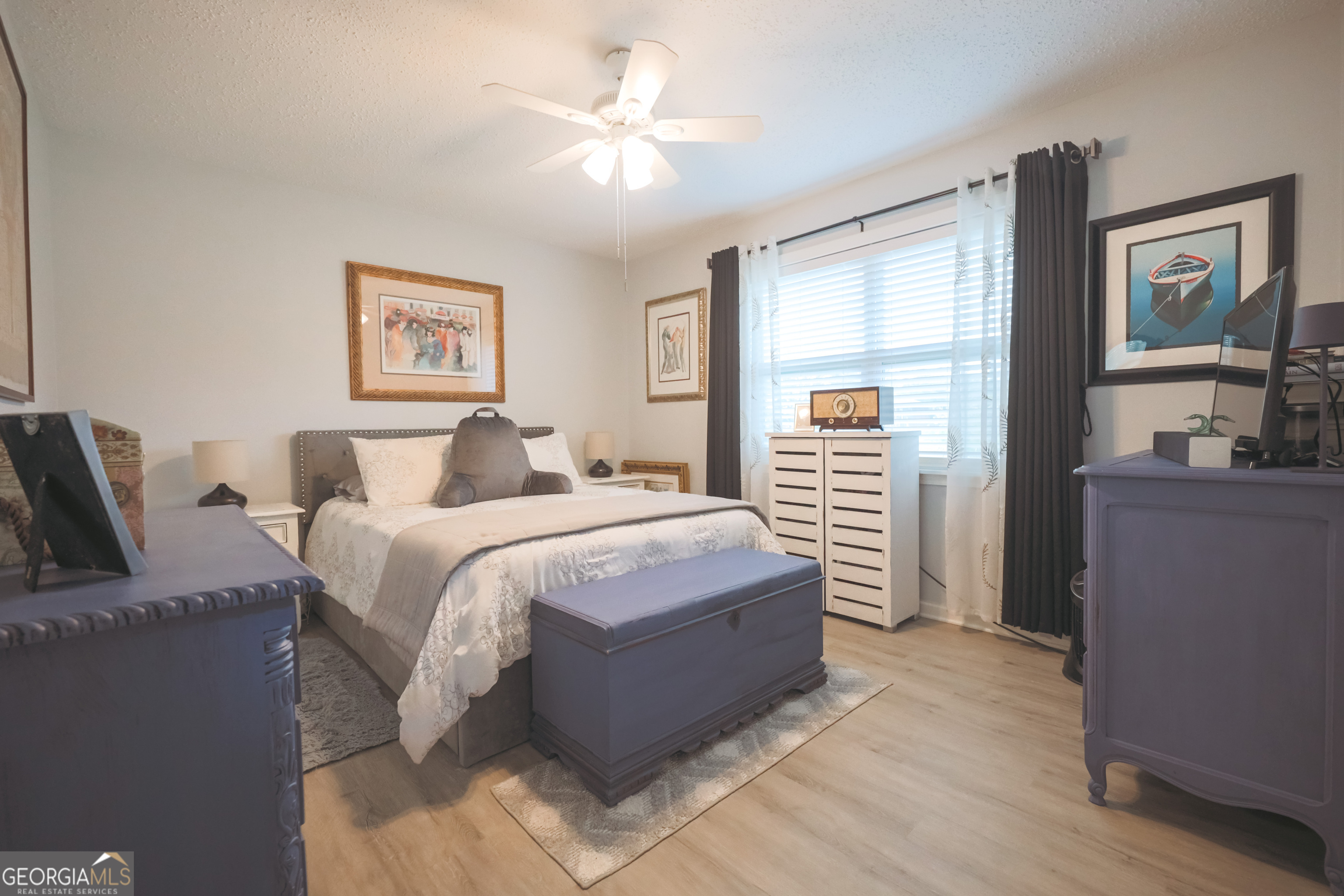 106 Beaver Drive Blackshear, GA 31516 - Photo 18 of 20 a bedroom with a bed and a chandelier