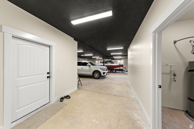 2591 East Washington Dam Road Washington, UT 84780 - Photo 57 of 67 Large garage space with light concrete flooring, white painted walls, and a black painted ceiling