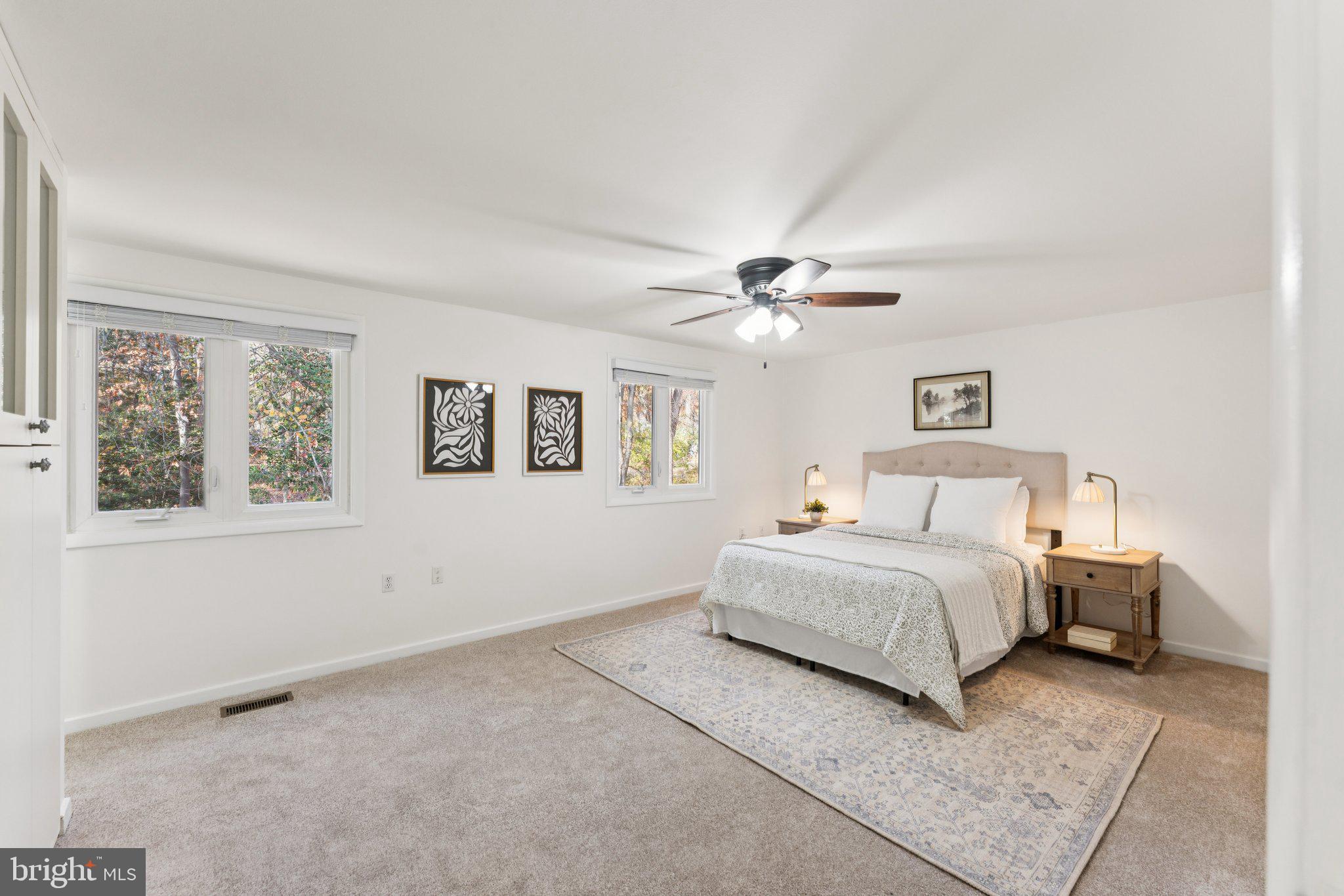 11234 Hunting Horn Lane Reston, VA 20191 - Photo 22 of 44 a spacious bedroom with a large bed and a window