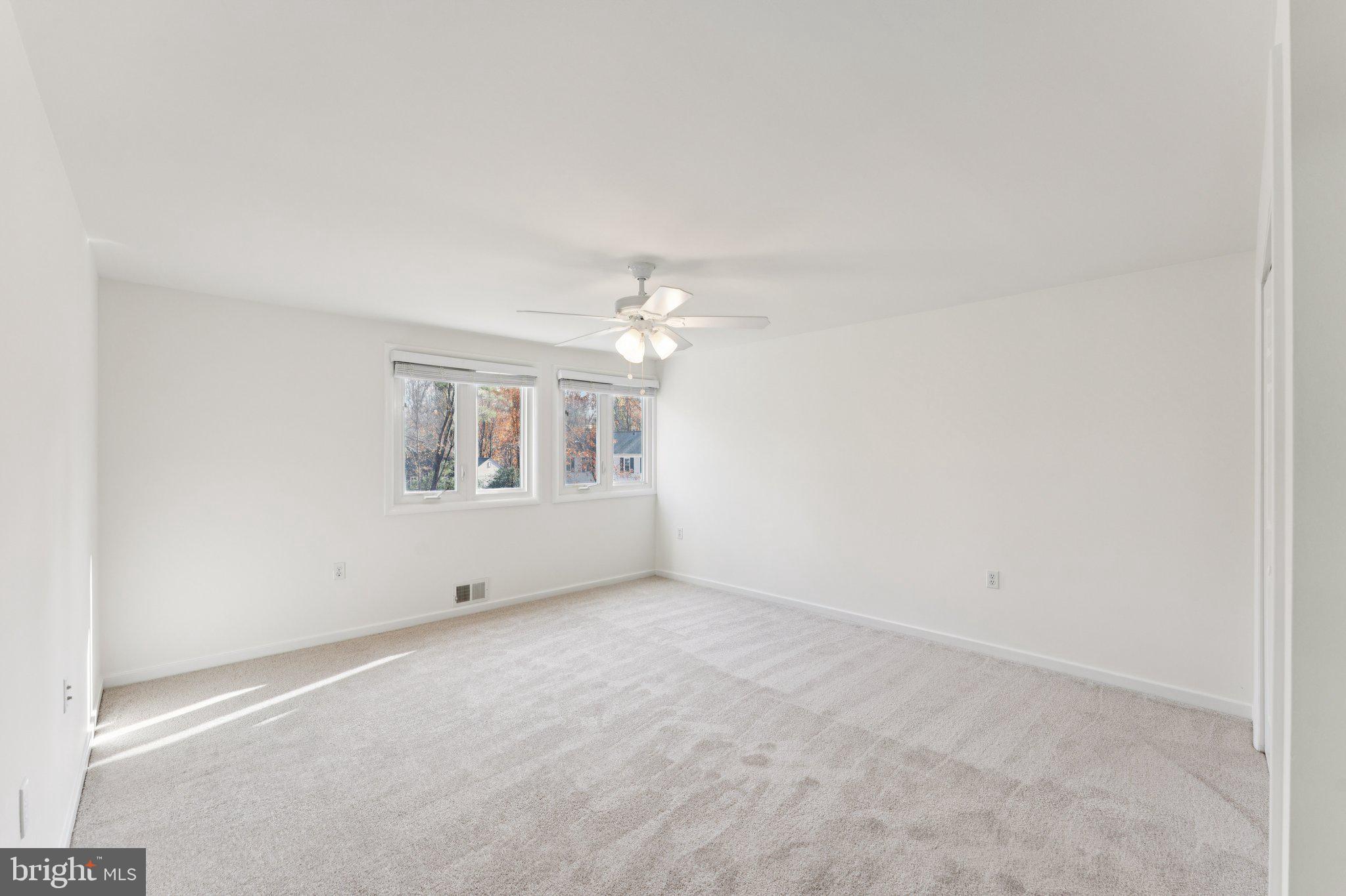 11234 Hunting Horn Lane Reston, VA 20191 - Photo 27 of 44 an empty room with chandelier fan and windows