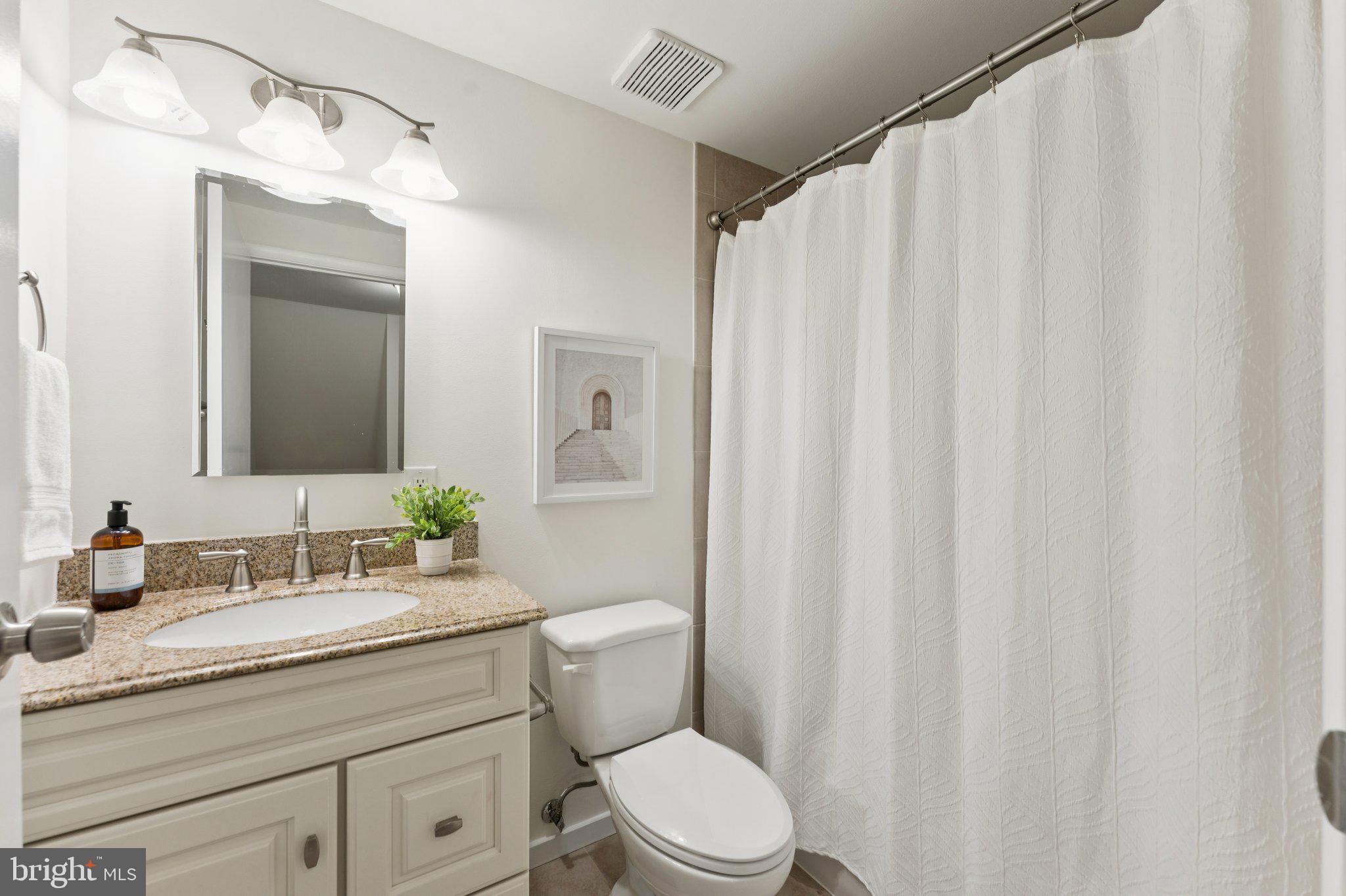 11234 Hunting Horn Lane Reston, VA 20191 - Photo 29 of 44 a bathroom with a granite countertop sink toilet and a mirror