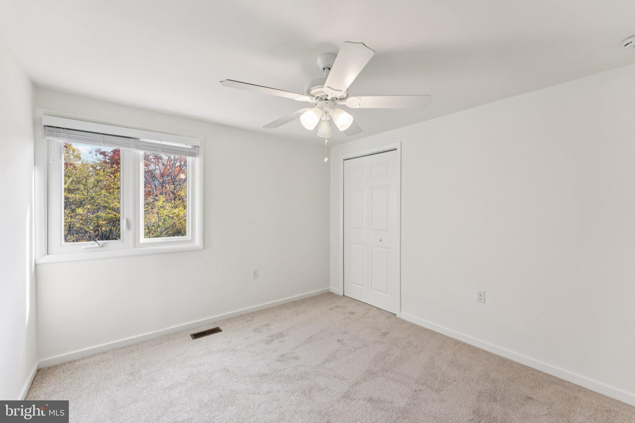 11234 Hunting Horn Lane Reston, VA 20191 - Photo 32 of 44 an empty room with windows and fan
