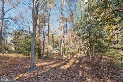 a view of a white house with a yard