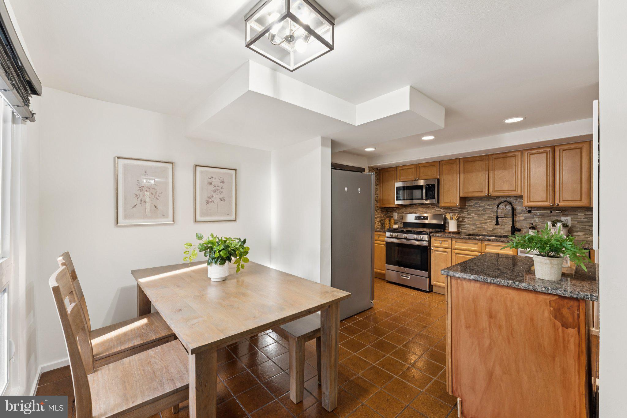 11234 Hunting Horn Lane Reston, VA 20191 - Photo 8 of 44 a kitchen with a table and chairs in it