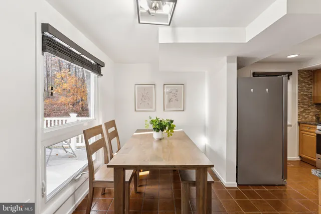 a view of a dining room with furniture and a window
