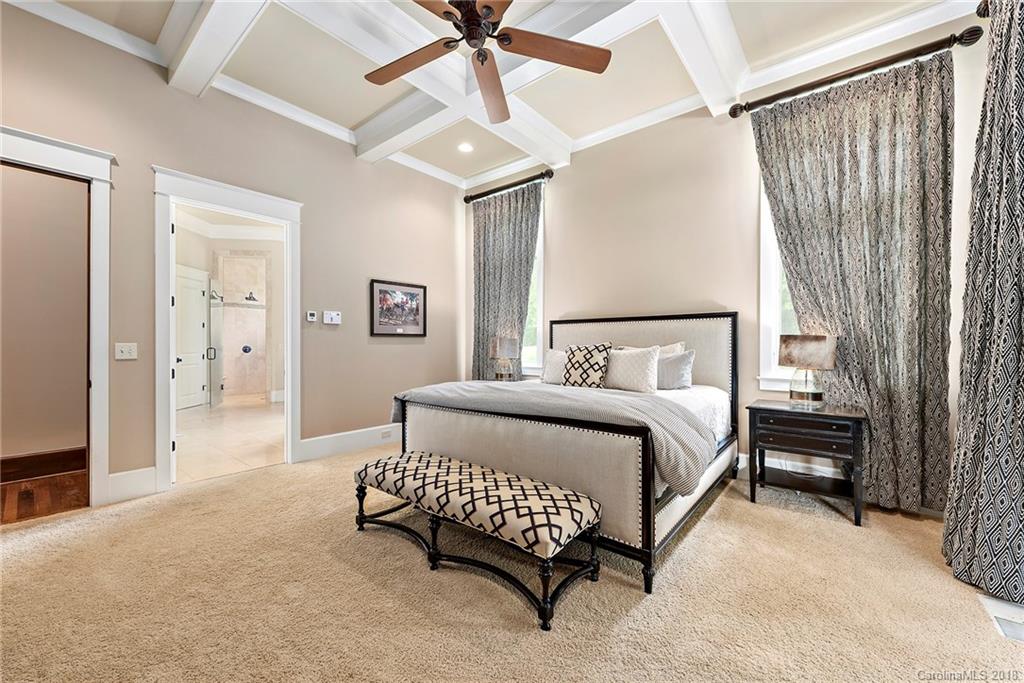10900 Unity Church Road Mooresville, NC 28115 - Photo 15 of 31 a spacious bedroom with a bed and a chandelier