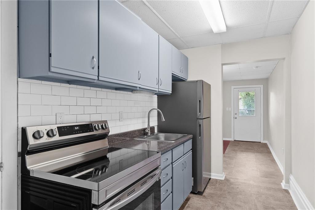 107 Dickman Street Carnegie, PA 15106 - Photo 12 of 47 a kitchen with a refrigerator stove and cabinets