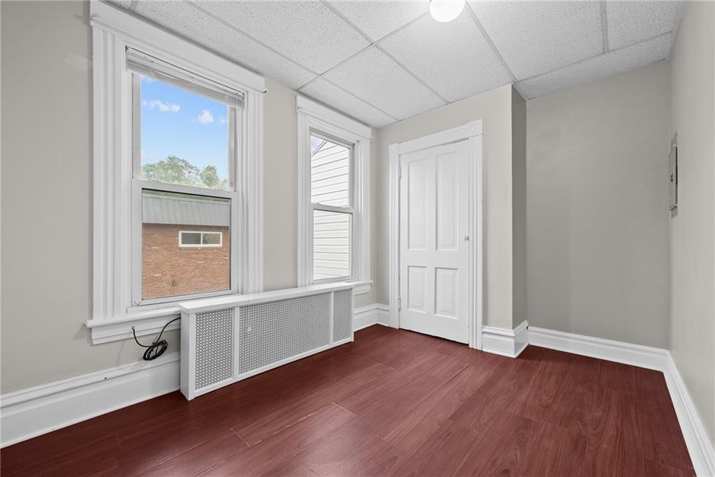 107 Dickman Street Carnegie, PA 15106 - Photo 14 of 47 an empty room with wooden floor and windows