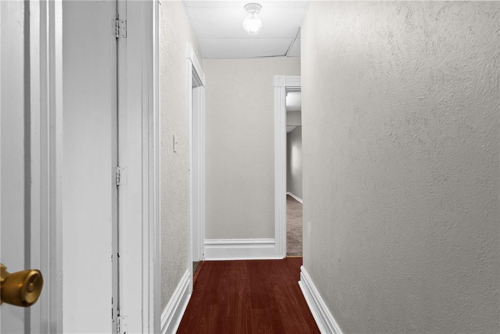 107 Dickman Street Carnegie, PA 15106 - Photo 16 of 47 a view of a hallway with wooden floor and a bathroom